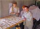 Show image 'Al Workman of WGM, Lori Walton and Ken Shortt examine drill core' in New Window