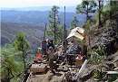 Show image 'Firestone QP John Cleary examining drill core on the TH-06-3 drill site' in New Window